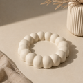 White bubble scallop ring holder tray on a beige surface