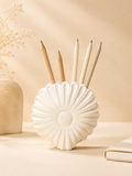 White shell-shaped ceramic pencil and brush holder with pencils