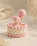 Teddy Nest candle - pink teddy holding a balloon sitting in a knit basket