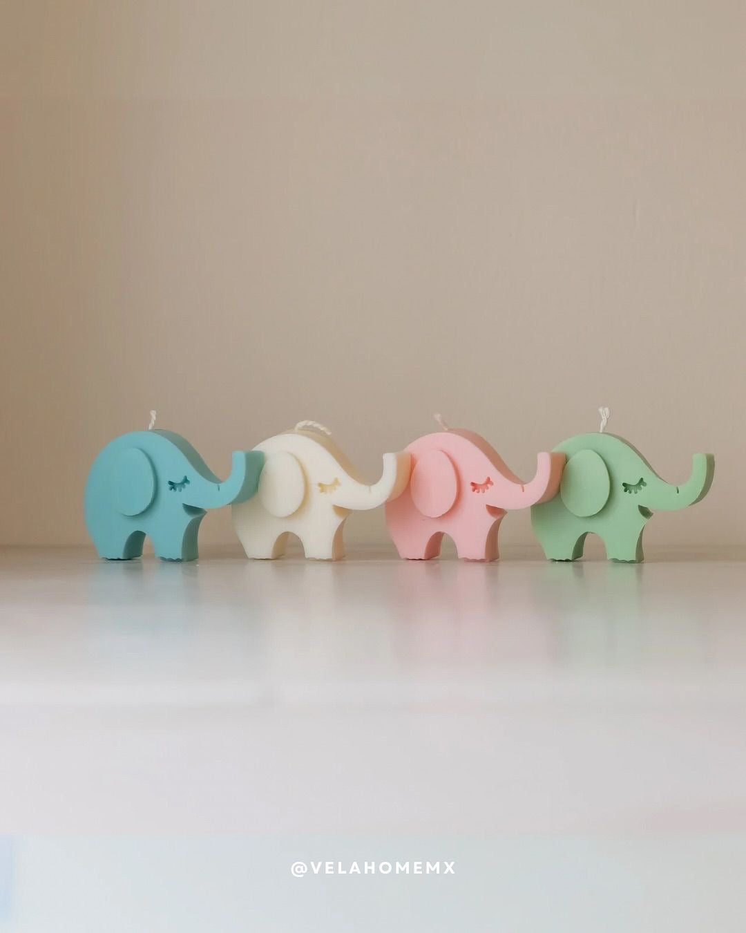 Elli elephant candles in pastel colors - blue, ivory, pink and green