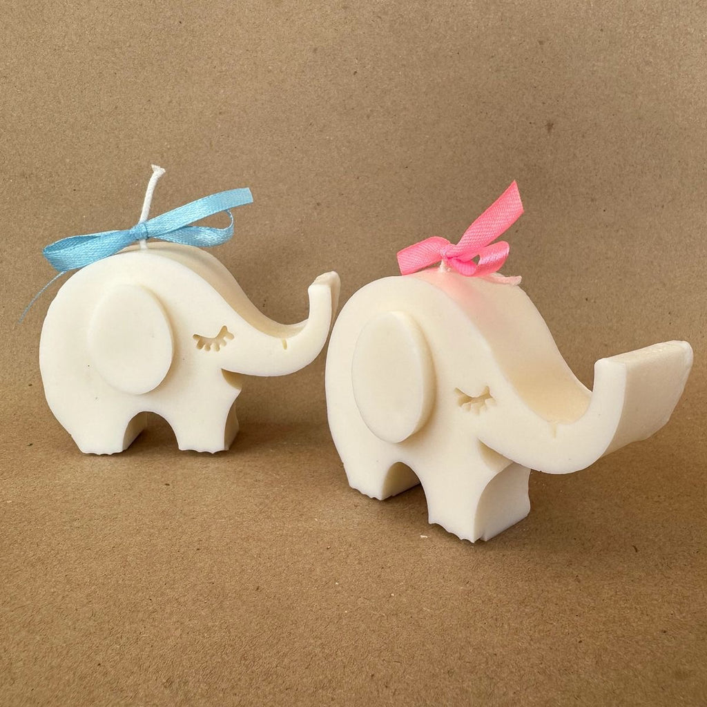 Ivory elephant candles with blue and pink ribbon bows