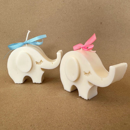 Ivory elephant candles with blue and pink ribbon bows