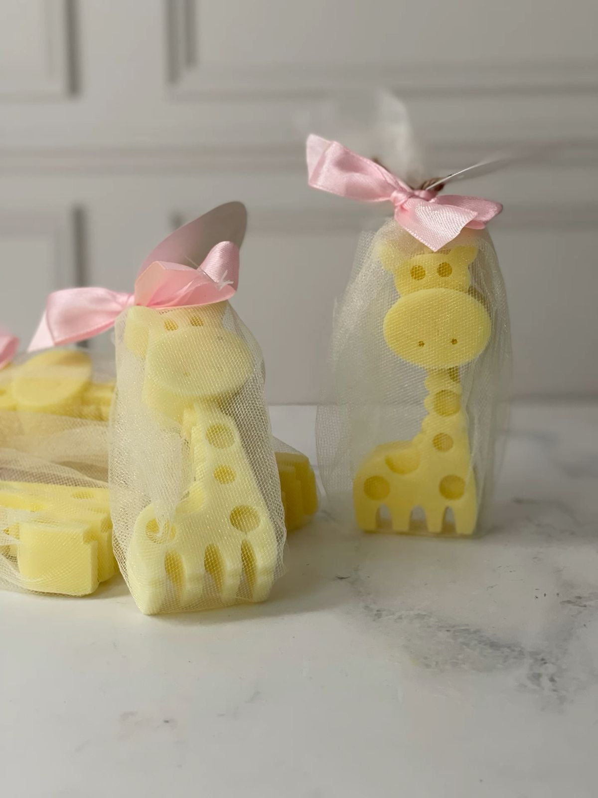 Gigi candles wrapped in organza bags with pink satin ribbon